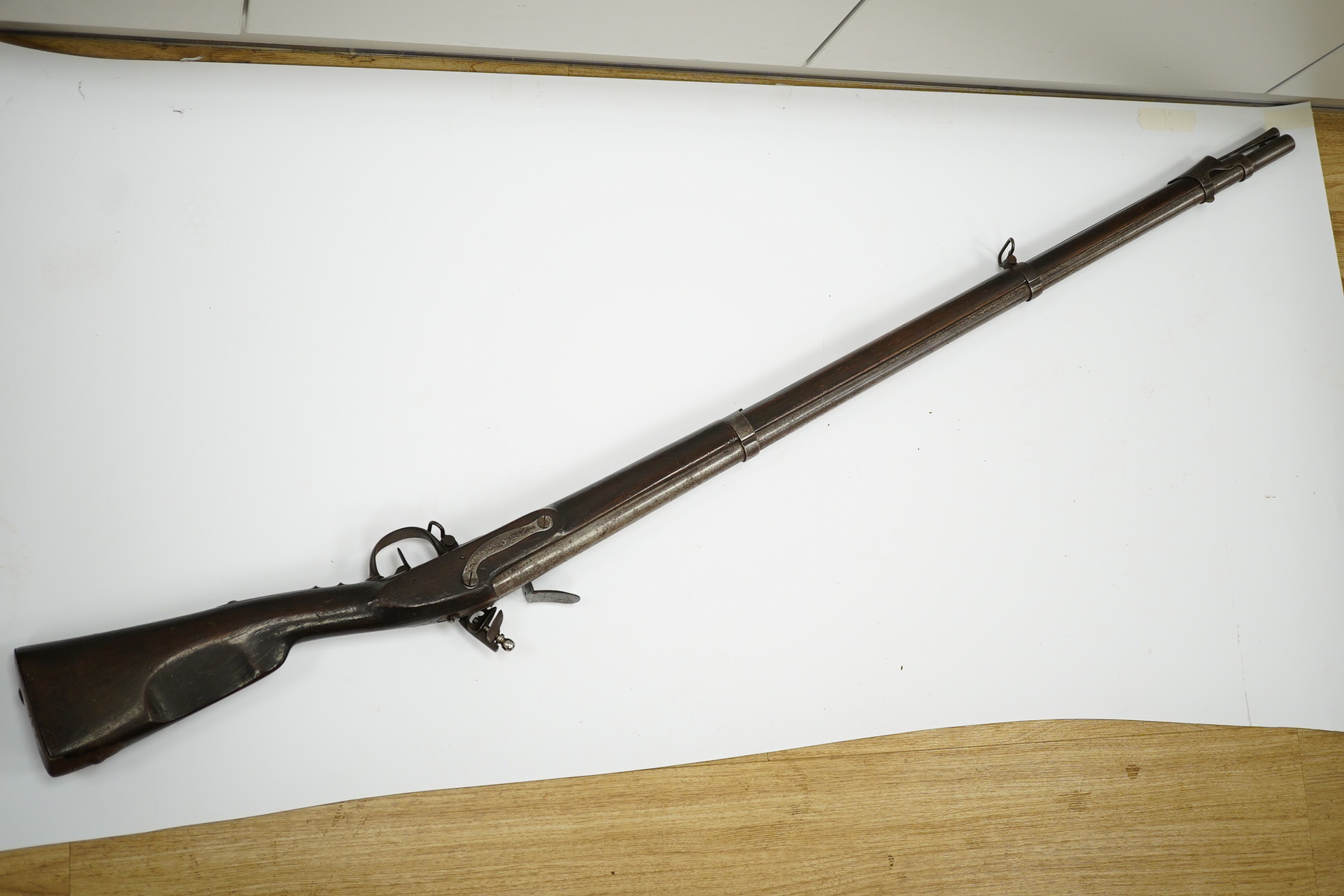 An 18mm French military flintlock musket, lock engraved St. Etienne Manufre Royale, regulation lock with brass pan, iron barrel and regulation iron mounts, with steel rammer. Condition - fair